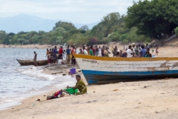 A woman washes clothes on the shoreline of Lake Malawi.