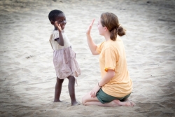 Amanda Kato plays with a young girl from the Senga Bay fishing village.